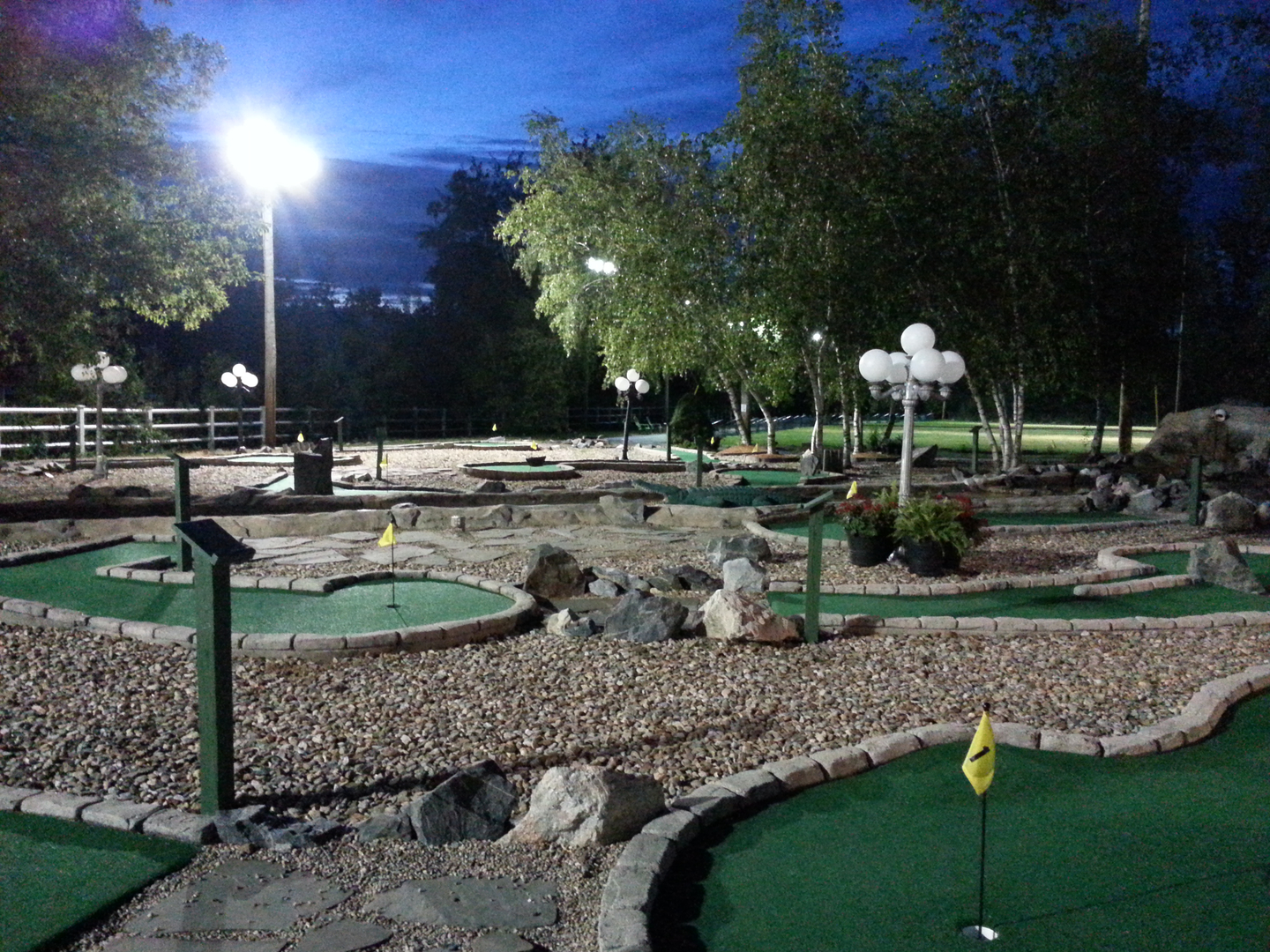 Mini golf course lit up at night